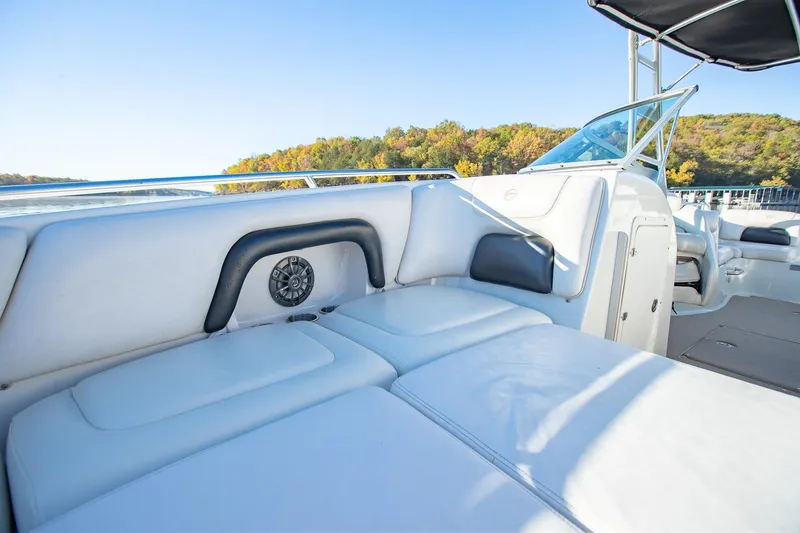 Slide: The Image of 2006 Crownline 270 BR boat interior with white seating and scenic lake view. - 13