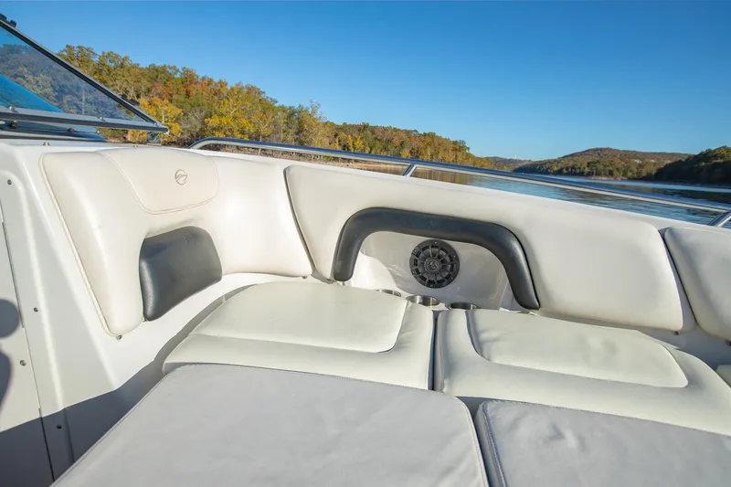 Slide: The Image of 2006 Crownline 270 BR boat interior with white seating, scenic lake view. - 15