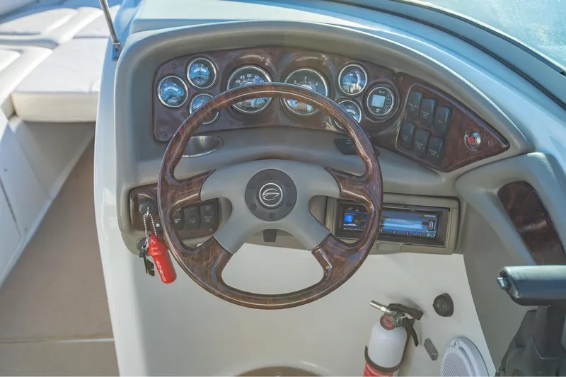 Slide: The Image of 2006 Crownline 270 BR boat dashboard with steering wheel and gauges. - 17