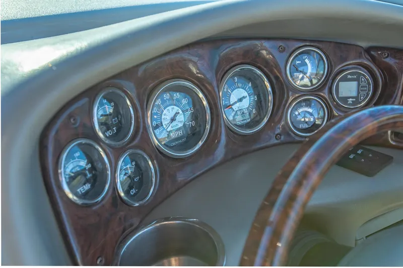Slide: The Image of Dashboard of 2006 Crownline 270 BR boat with multiple gauges and wood finish. - 18