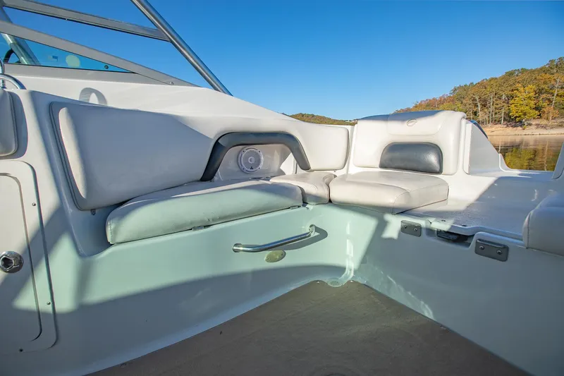 Slide: The Image of 2006 Crownline 270 BR boat interior with cushioned seating and scenic lake view. - 21