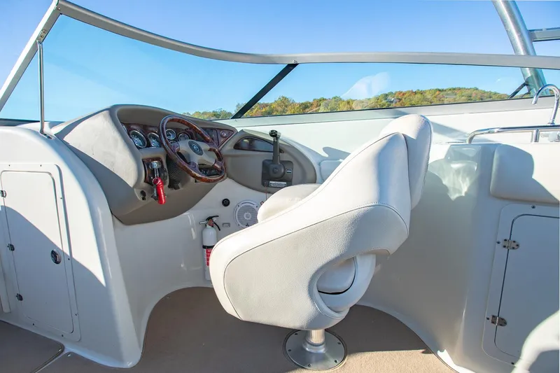 Slide: The Image of 2006 Crownline 270 BR boat cockpit with steering wheel and captain's chair. - 22