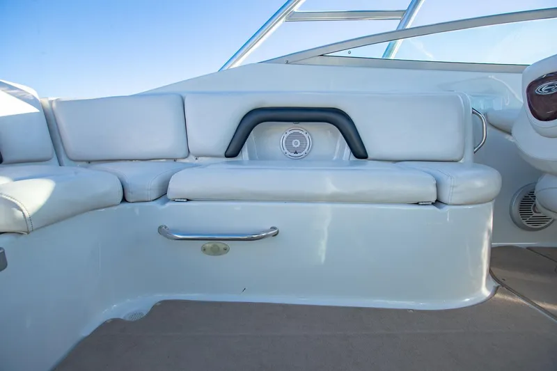 Slide: The Image of 2006 Crownline 270 BR boat interior with white seating and speaker. - 24
