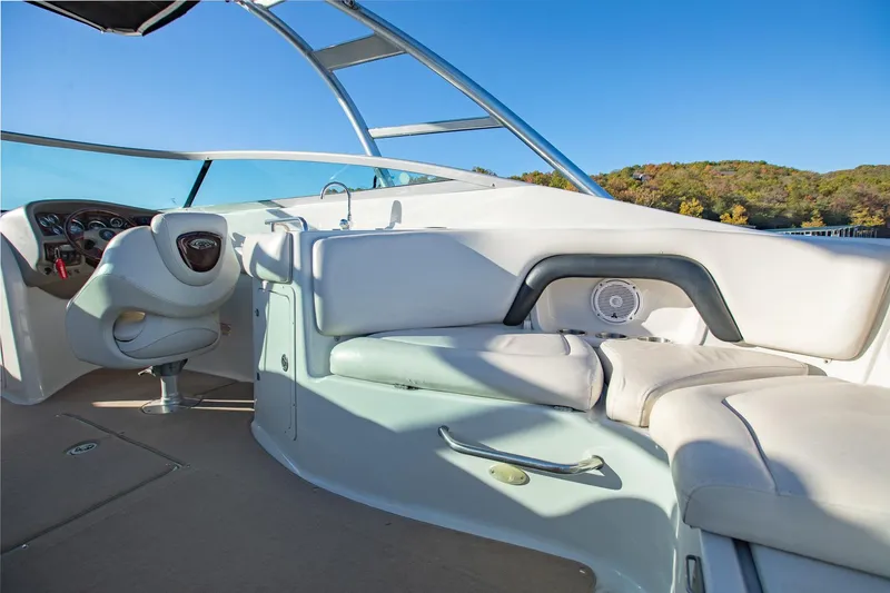 Slide: The Image of 2006 Crownline 270 BR boat interior with white seating and steering wheel. - 25