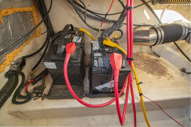 Slide: The Image of 2006 Crownline 270 BR boat batteries with connected cables in engine compartment. - 29