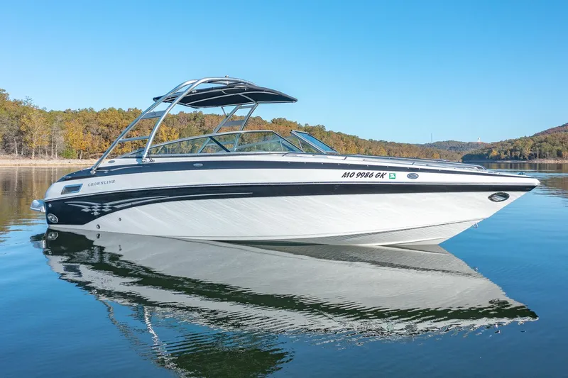 Slide: The Image of 2006 Crownline 270 BR boat on calm lake with clear blue sky. - 3