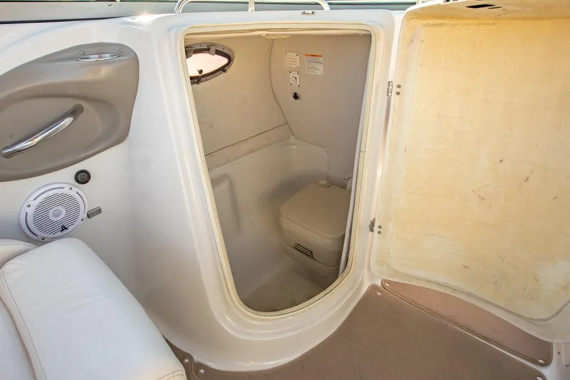 Slide: The Image of 2006 Crownline 270 BR boat interior with compact bathroom and seating area. - 31