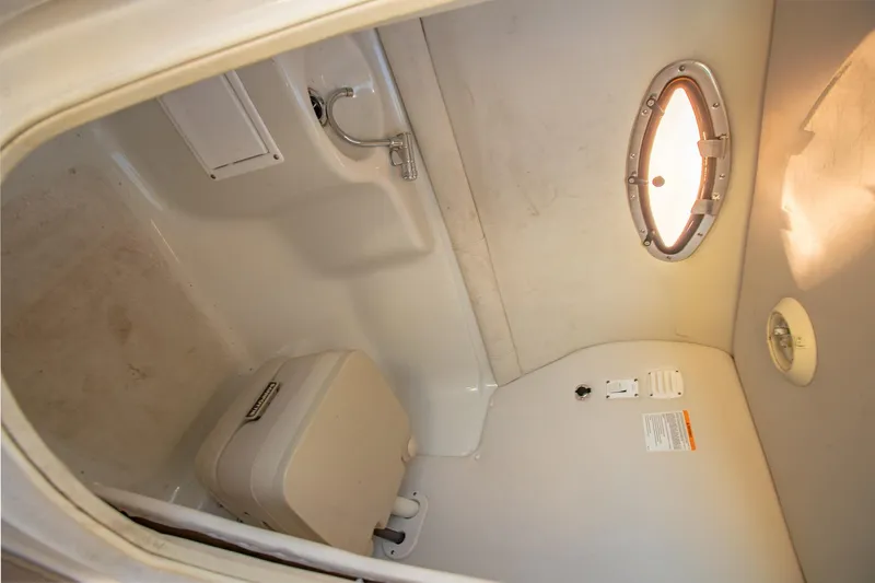 Slide: The Image of 2006 Crownline 270 BR boat interior bathroom with sink and porthole window. - 32