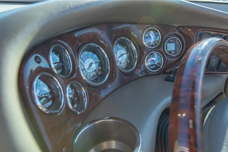 Slide: The Image of Dashboard of 2006 Crownline 270 BR boat with wood finish and gauges. - 34