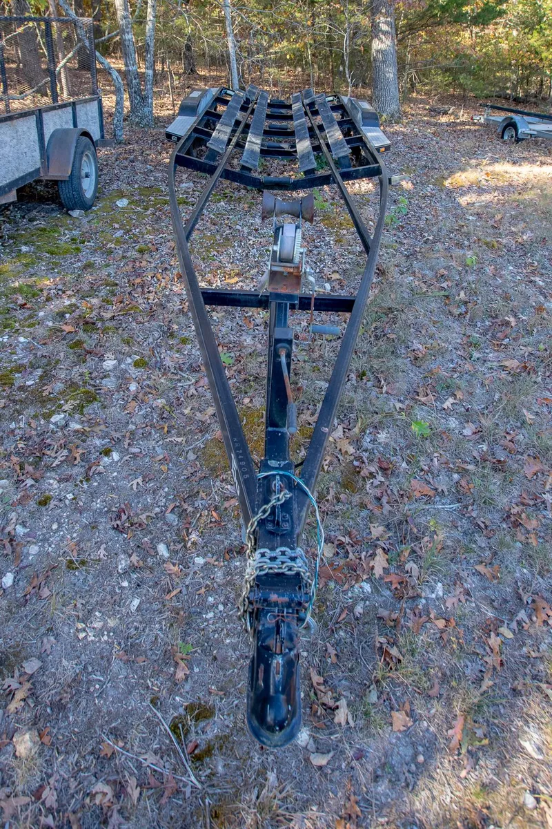 Slide: The Image of 2006 Crownline 270 BR boat trailer on grassy terrain. - 37