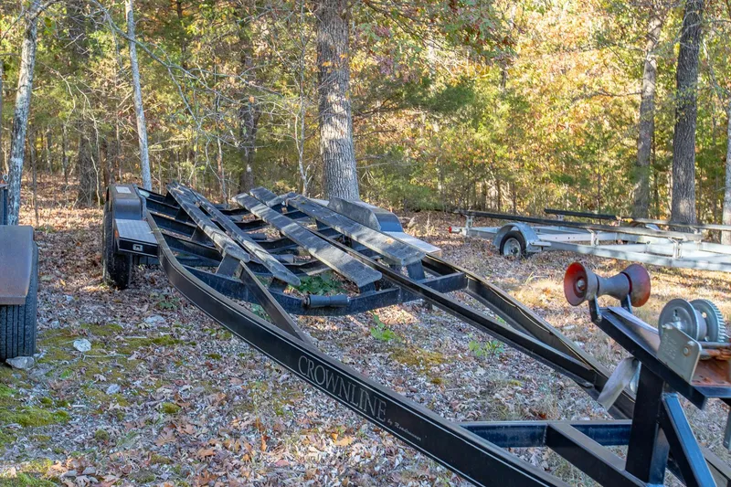Slide: The Image of Crownline 270 BR 2006 boat trailer in wooded area, autumn leaves scattered. - 38