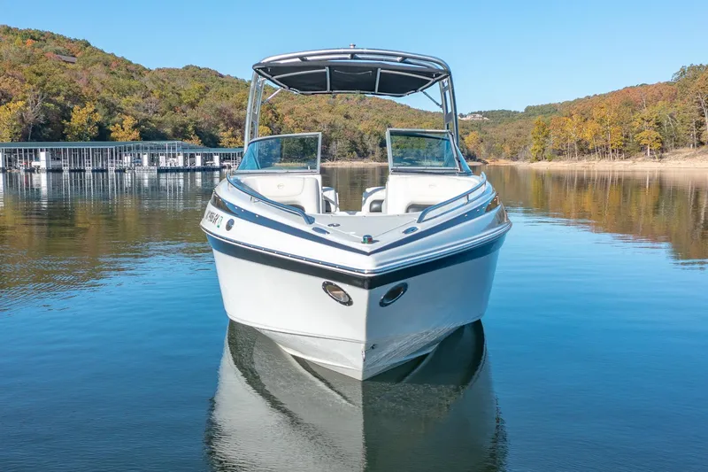 Slide: The Image of 2006 Crownline 270 BR boat on a calm lake with scenic background. - 4