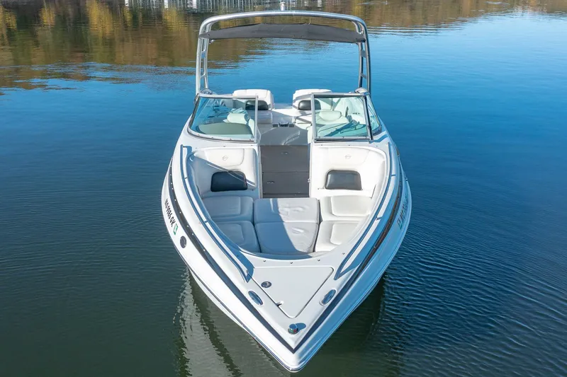 Slide: The Image of 2006 Crownline 270 BR boat on calm water, front view. - 5