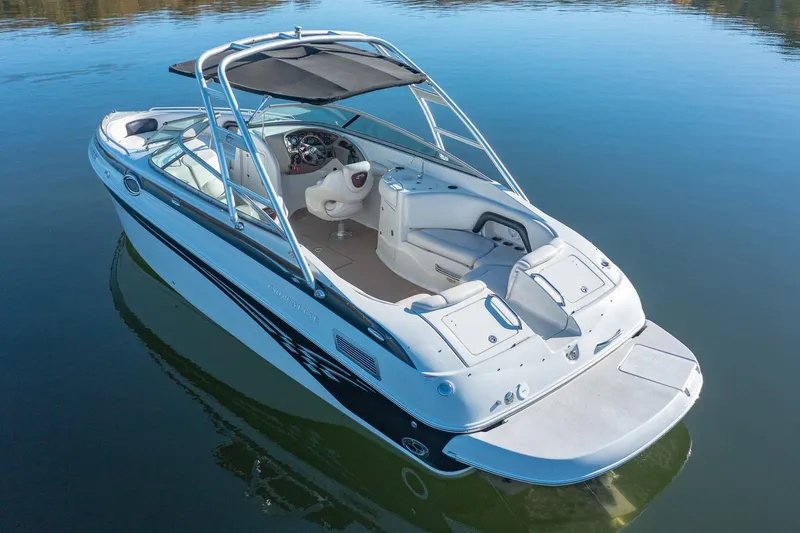Slide: The Image of 2006 Crownline 270 BR boat on calm water, featuring sleek design and spacious seating. - 7