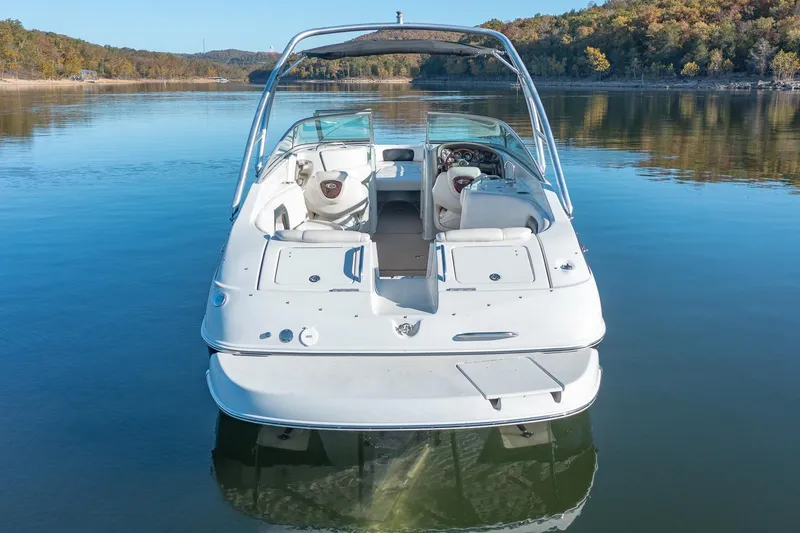 Slide: The Image of 2006 Crownline 270 BR boat on a serene lake with scenic background. - 8