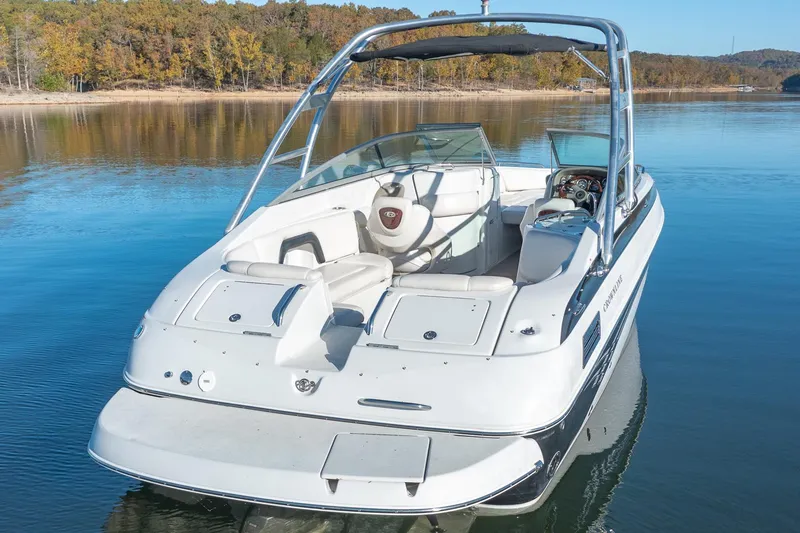 Slide: The Image of 2006 Crownline 270 BR boat on a calm lake with scenic background. - 9