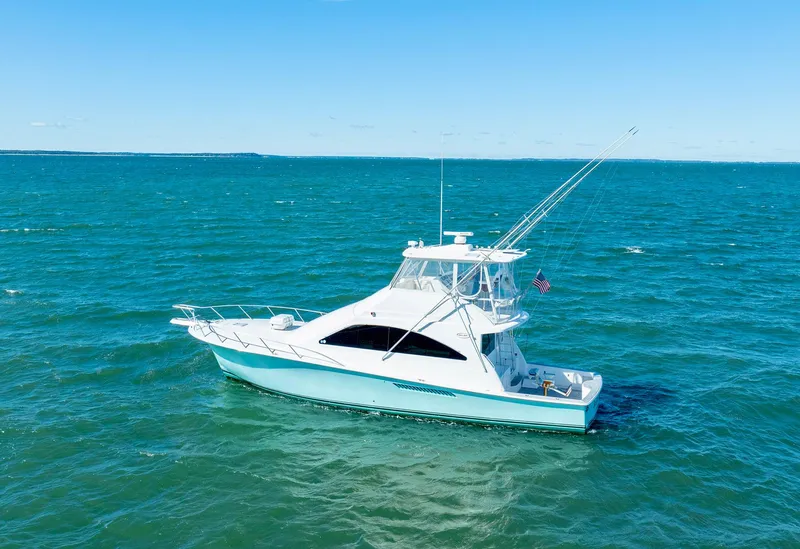 Slide: The Image of 2005 Ocean Yachts 50 Super Sport on open sea, clear blue sky. - 0