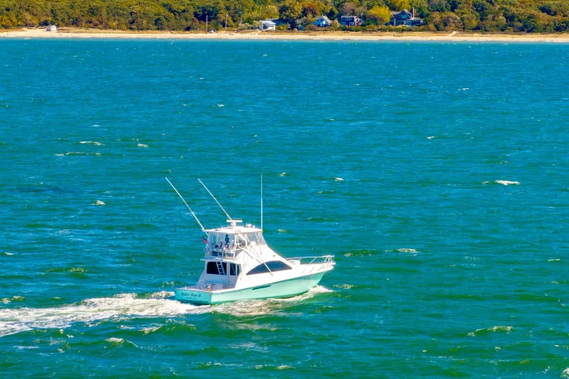 Slide: The Image of 2005 Ocean Yachts 50 Super Sport cruising on a vibrant blue sea. - 10