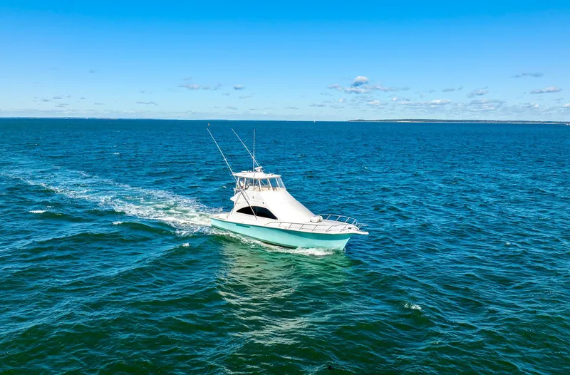 Slide: The Image of 2005 Ocean Yachts 50 Super Sport cruising on open blue sea. - 13