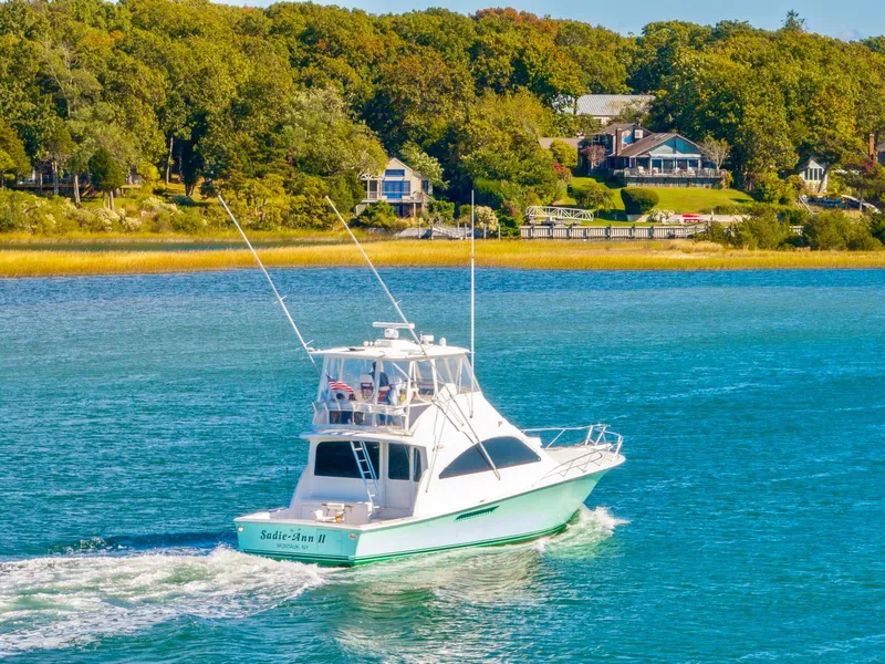 Slide: The Image of 2005 Ocean Yachts 50 Super Sport cruising on a scenic waterway with lush greenery. - 14