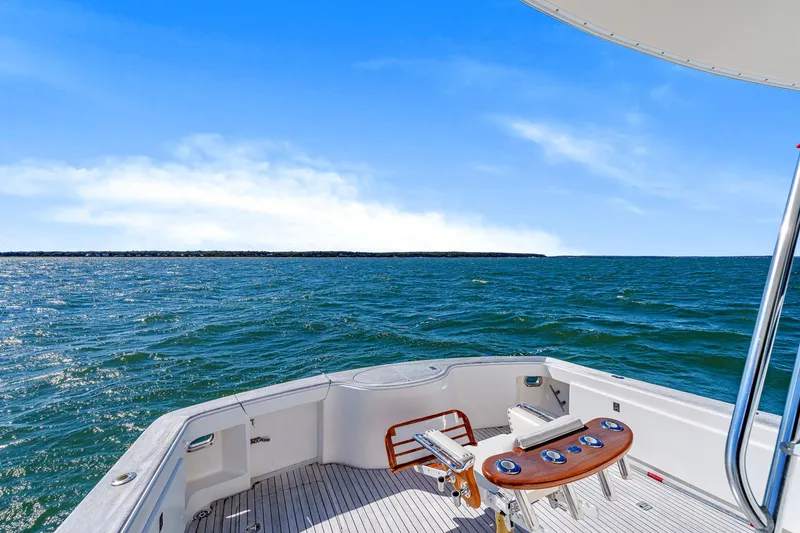Slide: The Image of 2005 Ocean Yachts 50 Super Sport on open sea, clear blue sky, fishing chair visible. - 22