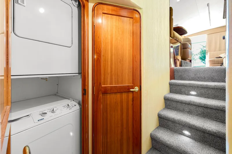 Slide: The Image of Laundry area and carpeted stairs inside 2005 Ocean Yachts 50 Super Sport. - 28