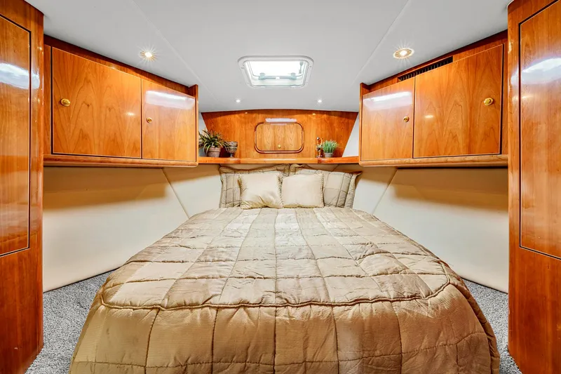 Slide: The Image of Luxurious cabin interior of 2005 Ocean Yachts 50 Super Sport with wood paneling and cozy bedding. - 32