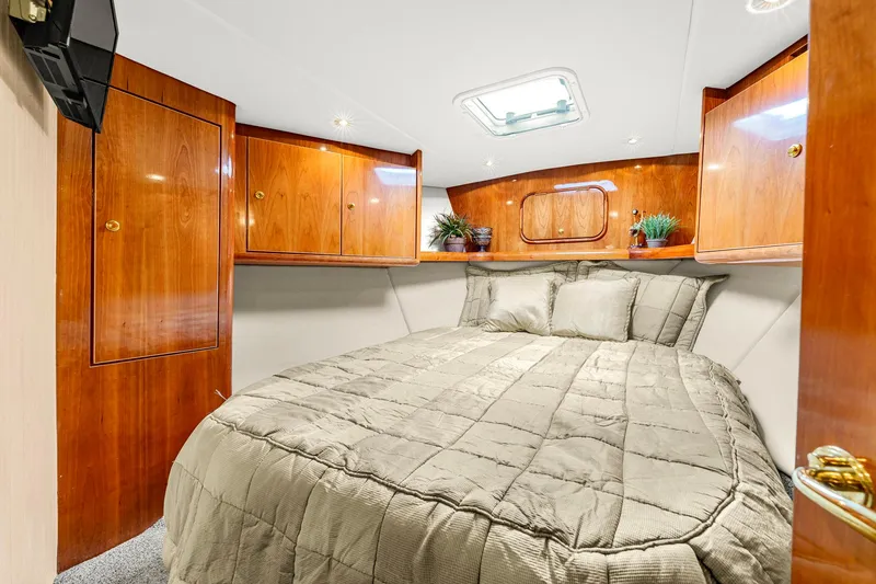 Slide: The Image of Luxurious cabin interior of 2005 Ocean Yachts 50 Super Sport with wood finish and cozy bedding. - 34