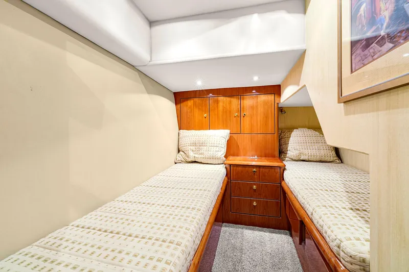 Slide: The Image of 2005 Ocean Yachts 50 Super Sport cabin with twin beds and wooden cabinetry. - 35