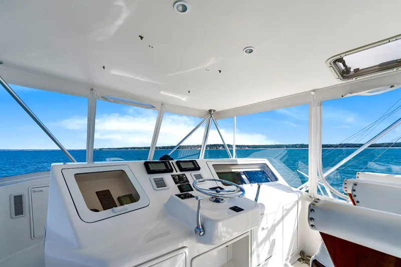 Slide: The Image of 2005 Ocean Yachts 50 Super Sport helm with ocean view, featuring modern navigation equipment. - 42