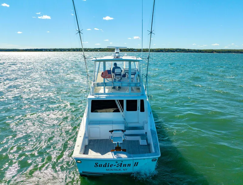 Slide: The Image of 2005 Ocean Yachts 50 Super Sport cruising on open water under clear skies. - 7