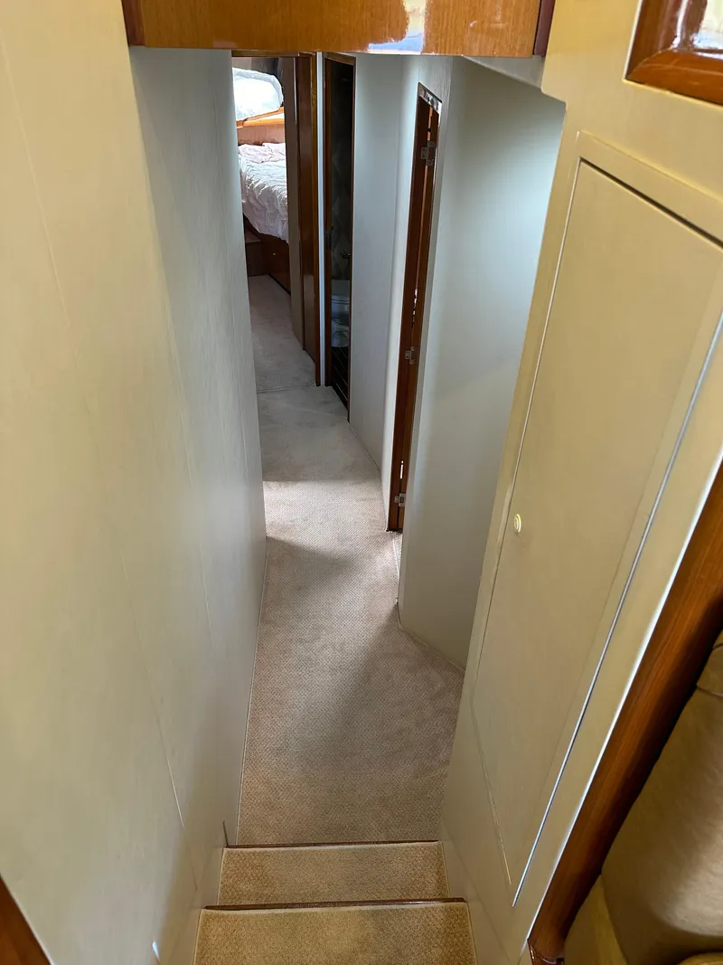 Slide: The Image of Luxurious interior of a 1999 Viking 55 Convertible yacht with wood finishes and modern amenities. - 14