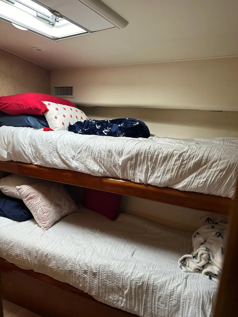 Slide: The Image of Interior of 1999 Viking 55 Convertible yacht with cozy dining area and wood accents. - 16