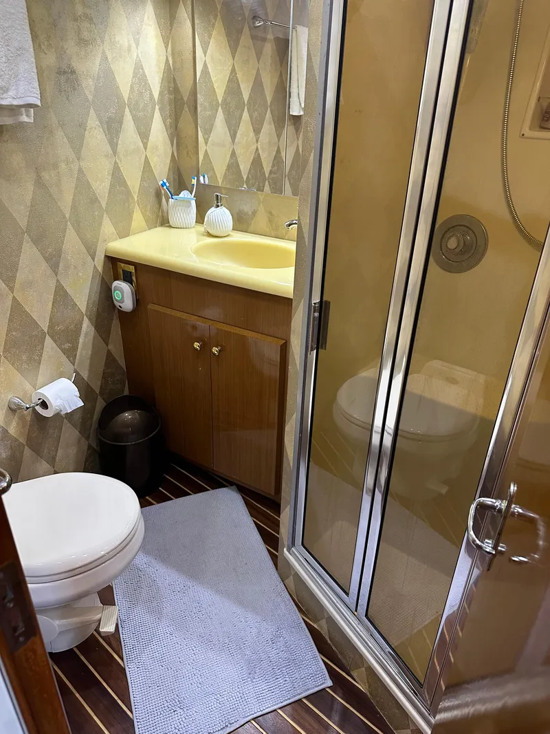 Slide: The Image of 1999 Viking 55 Convertible yacht kitchen with wood flooring and modern countertops. - 18