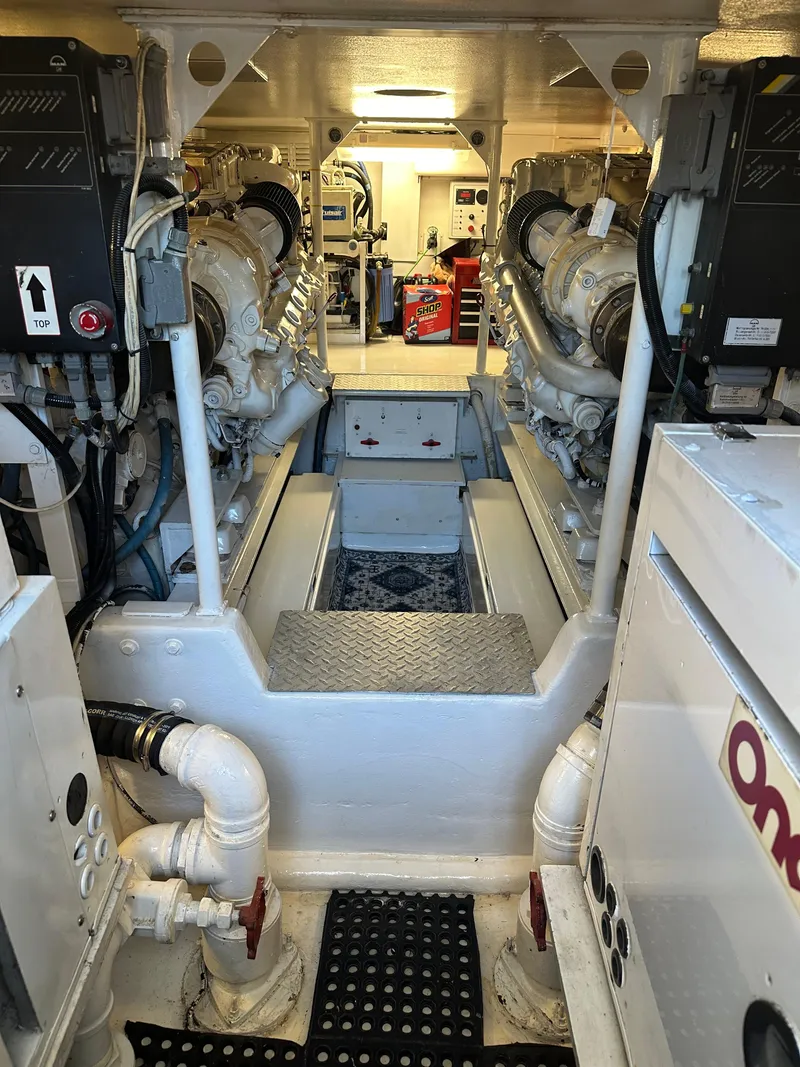 Slide: The Image of Engine room of 1999 Viking 55 Convertible yacht, showcasing dual engines and equipment. - 20