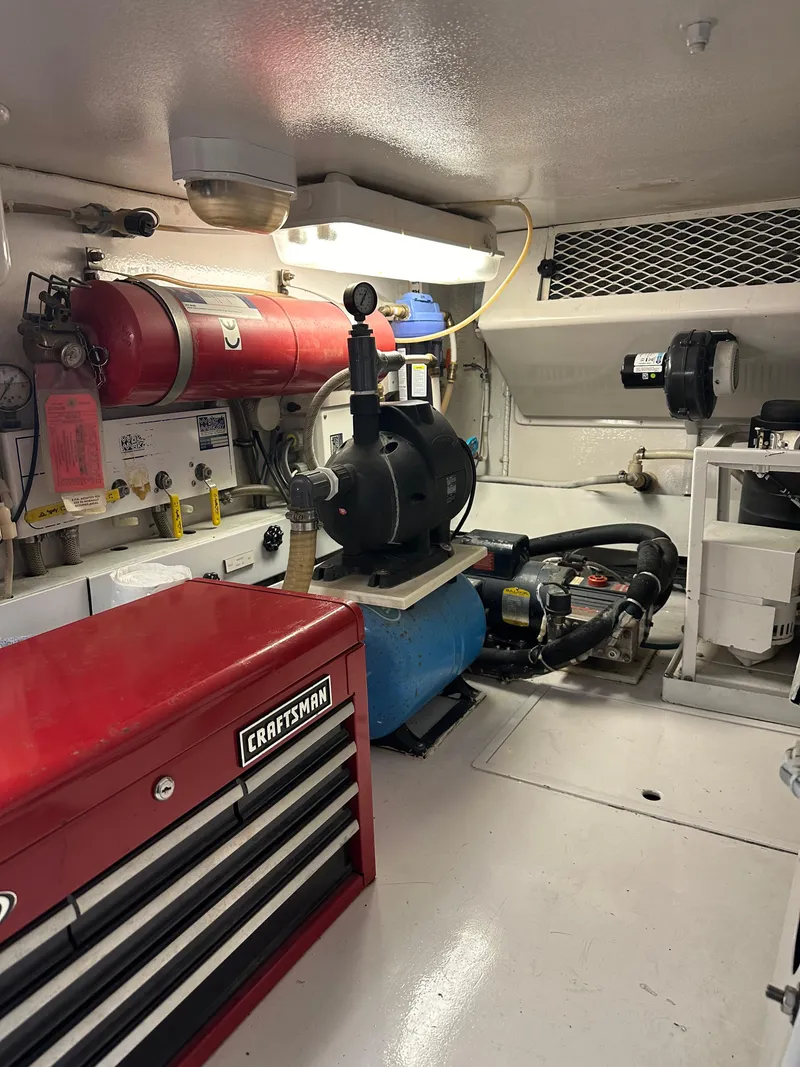 Slide: The Image of Engine room of 1999 Viking 55 Convertible with tools and equipment. - 23