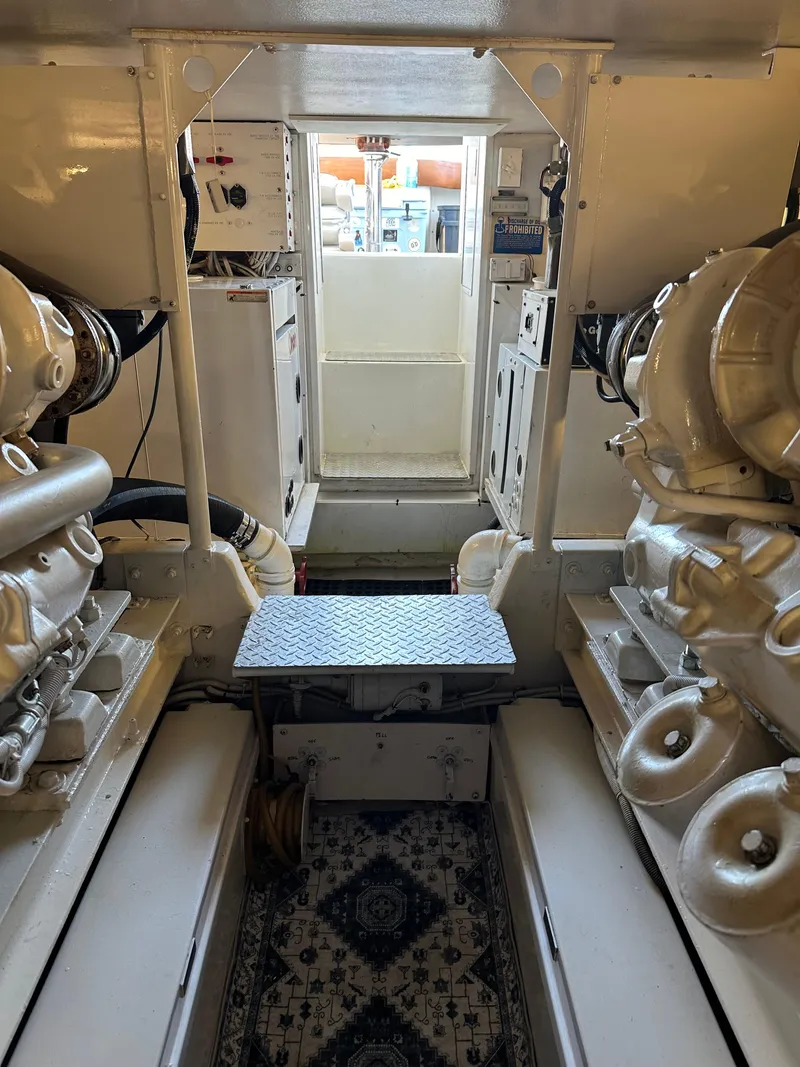 Slide: The Image of Engine room of 1999 Viking 55 Convertible yacht, showcasing machinery and equipment. - 27