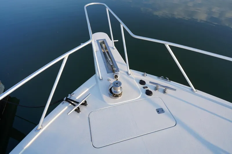 Slide: The Image of Bow of 1999 Viking 55 Convertible yacht with anchor and railing. - 35