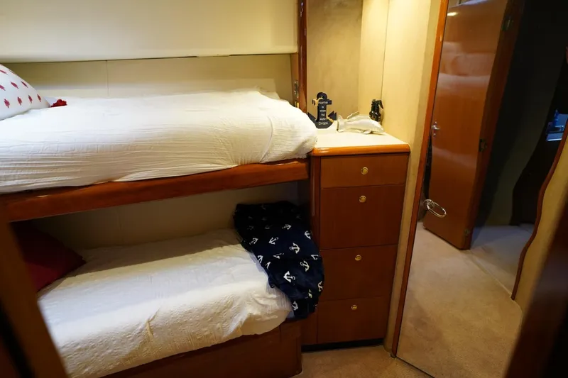 Slide: The Image of Bunk beds in 1999 Viking 55 Convertible yacht cabin with wooden cabinetry. - 40