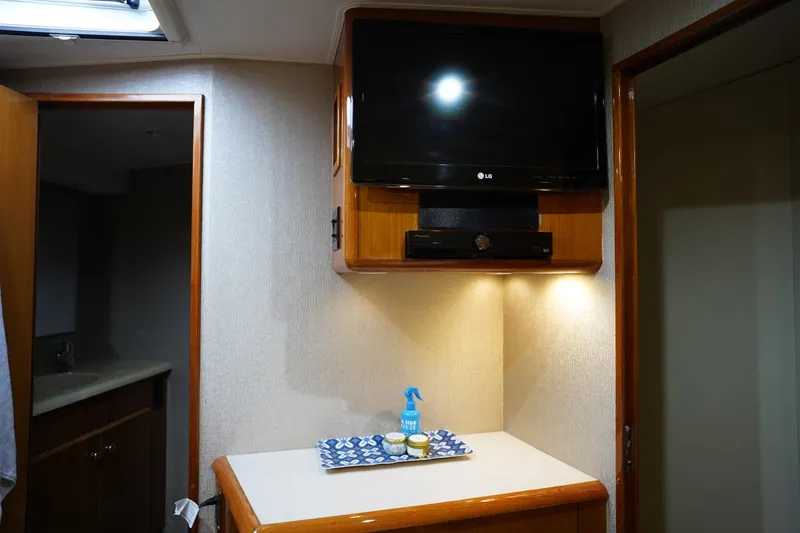 Slide: The Image of Interior of 1999 Viking 55 Convertible yacht with TV and countertop accessories. - 46
