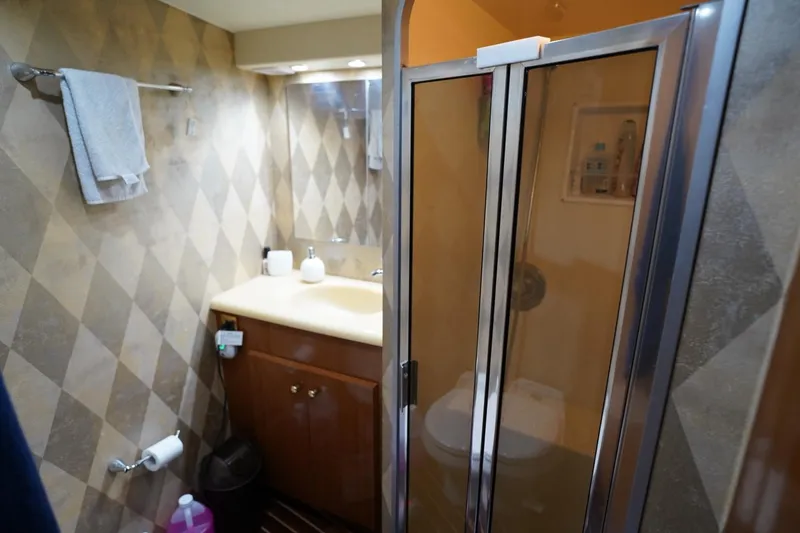 Slide: The Image of Bathroom interior of 1999 Viking 55 Convertible yacht with shower and vanity. - 47