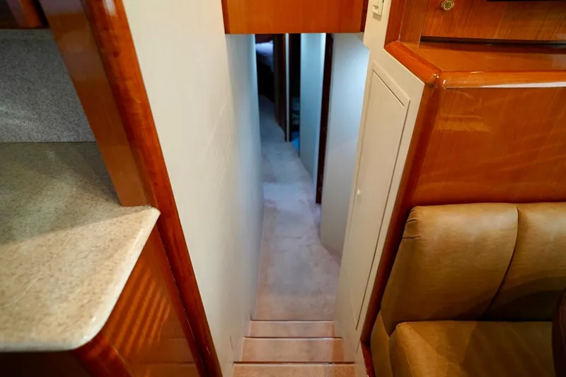 Slide: The Image of Interior hallway of a 1999 Viking 55 Convertible yacht, featuring wooden finishes. - 50