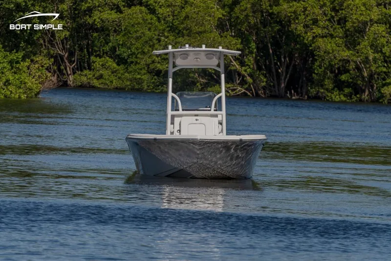 Slide: The Image of 2023 Sea Pro 199 Deep V Center Console boat on calm water, surrounded by lush greenery. - 3