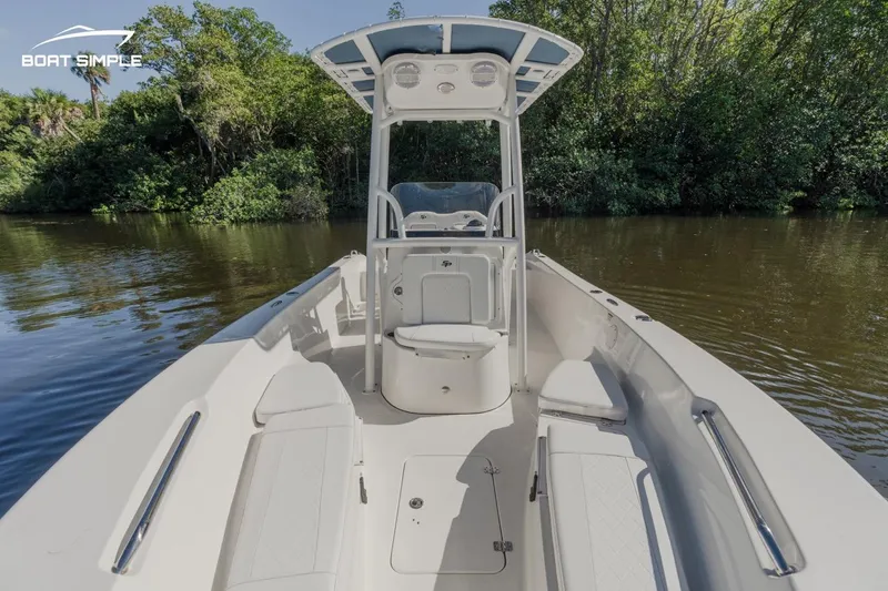 Slide: The Image of 2023 Sea Pro 199 Deep V Center Console boat on calm water, surrounded by lush greenery. - 5