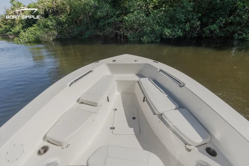 Slide: The Image of 2023 Sea Pro 199 Deep V Center Console boat interior with cushioned seating and water view. - 6