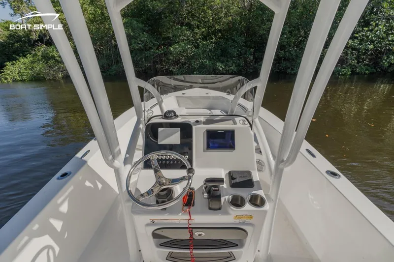 Slide: The Image of 2023 Sea Pro 199 Deep V Center Console boat on calm water, featuring modern controls. - 7