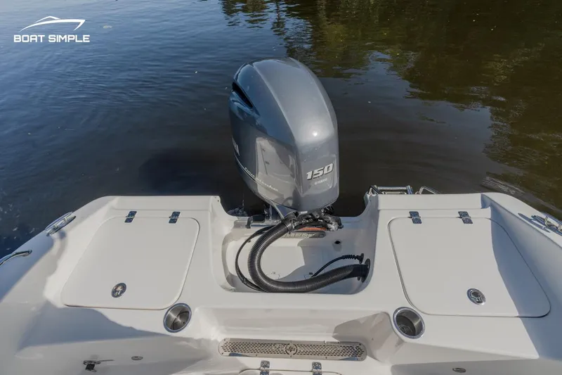 Slide: The Image of 2023 Sea Pro 199 Deep V Center Console with 150 HP outboard motor on calm water. - 9