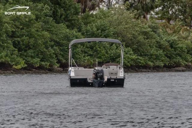 Slide: The Image of 2023 Starcraft SVX 171 OB boat on water, surrounded by lush greenery. - 3