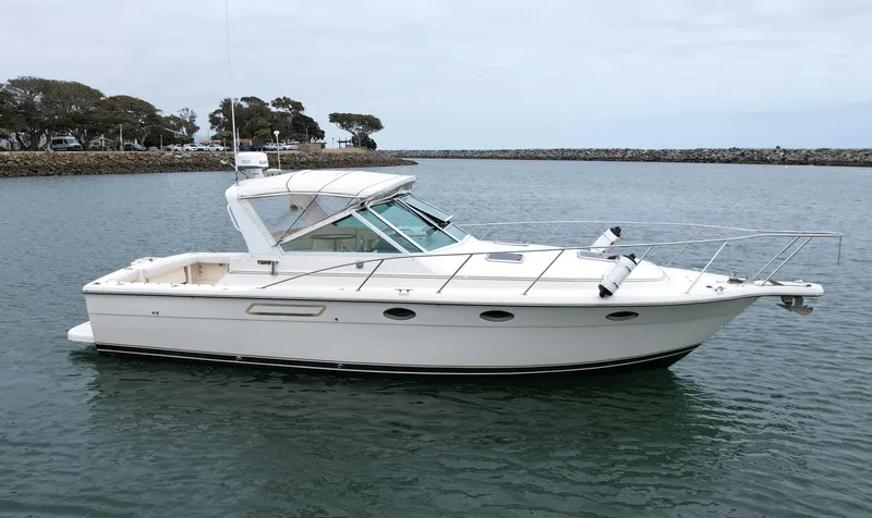 Slide: The Image of 1998 Tiara Yachts 3100 Open boat on calm water, side view. - 0