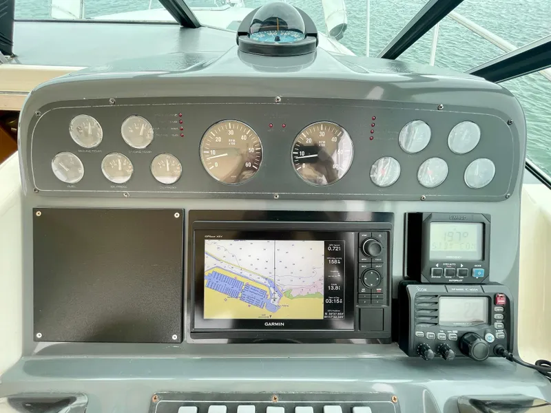Slide: The Image of Dashboard of 1998 Tiara Yachts 3100 Open with navigation and control instruments. - 13